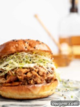 chicken is added to the slow cooker with honey bourbon bbq sauce, to make sweet, smoky, tender bbq chicken sandwiches