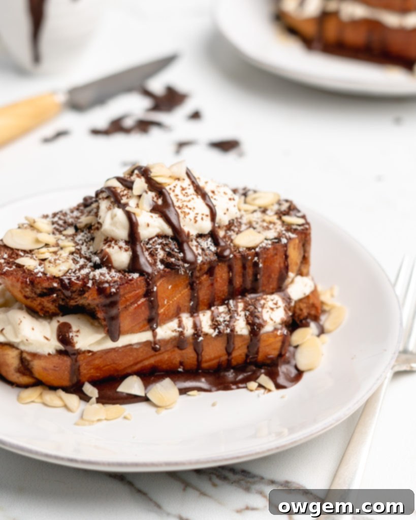 Fluffy Tiramisu flavored French Toast is topped with a delicious dollop of mascarpone whip cream, then drizzled with dark chocolate ganache