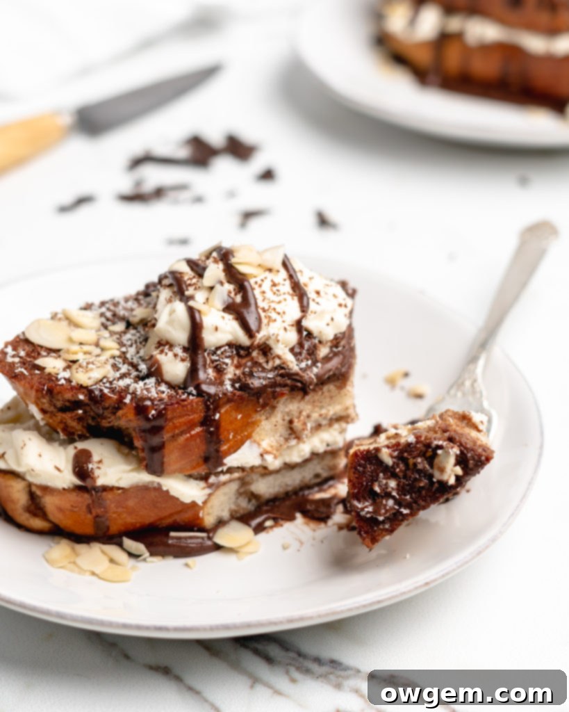 Fluffy Tiramisu flavored French Toast is topped with a delicious dollop of mascarpone whip cream, then drizzled with dark chocolate ganache
