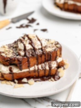Fluffy Tiramisu flavored French Toast is topped with a delicious dollop of mascarpone whip cream, then drizzled with dark chocolate ganache