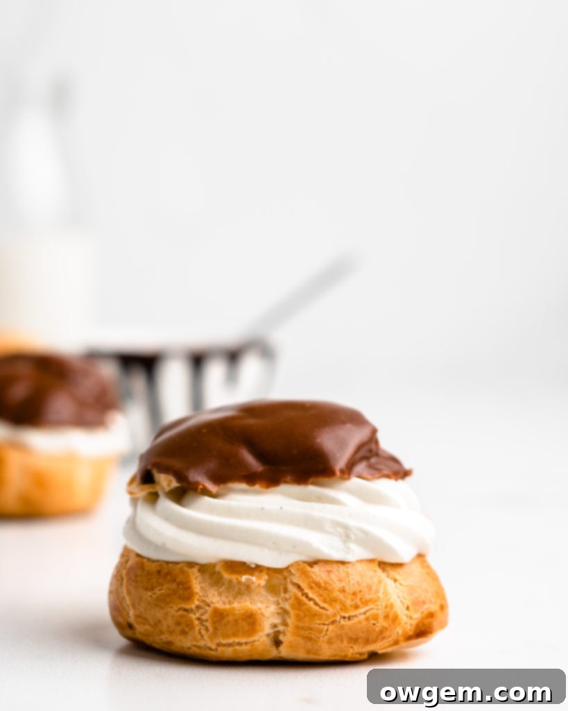 Perfectly puffed cream puffs are filled with a vanilla bean creme diplomat and topped with a chocolate glaze