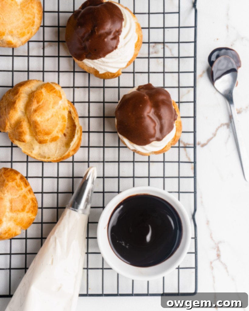 Perfectly puffed cream puffs are filled with a vanilla bean creme diplomat and topped with a chocolate glaze