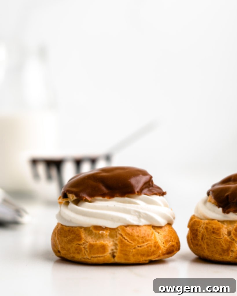 Perfectly puffed cream puffs are filled with a vanilla bean creme diplomat and topped with a chocolate glaze