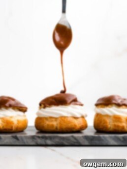 Perfectly puffed cream puffs are filled with a vanilla bean creme diplomat and topped with a chocolate glaze