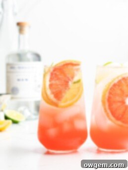 A refreshing Gin, Elderflower, and Aloe Spritzer, garnished with grapefruit, ready to be served.