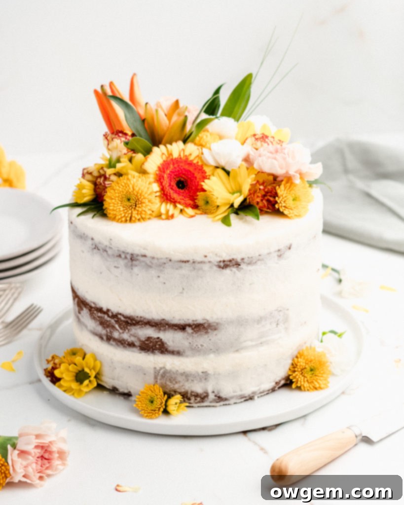 Carrot Cake Perfection: Ultra Moist with Cream Cheese Frosting 3 Close-up of a slice of ultra moist carrot cake revealing its dense texture and specks of warm spices and finely shredded carrots, topped with rich cream cheese frosting.