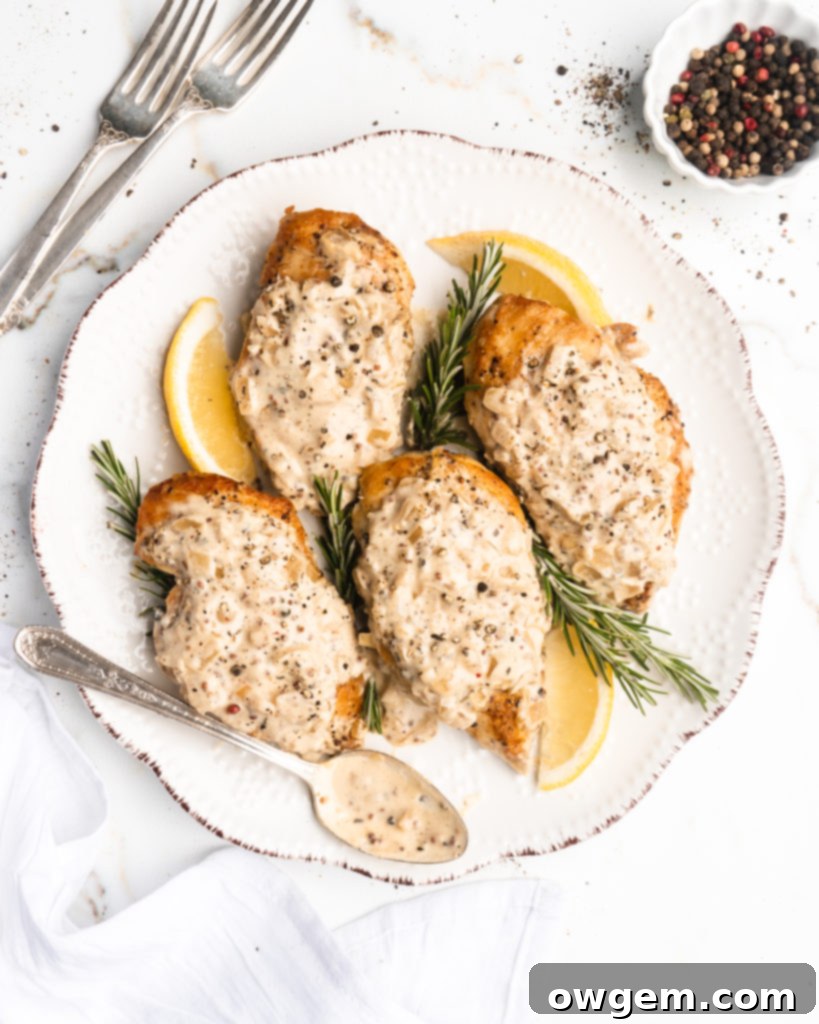 Individual serving of creamy maple mustard chicken, garnished with fresh herbs, ready to be enjoyed.