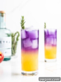 A vibrant, layered cocktail featuring a gradient from yellow to lavender, garnished with fresh rosemary. Ingredients include vodka, peach syrup, yuzu juice, sake, butterfly pea flower tea, and soda water.