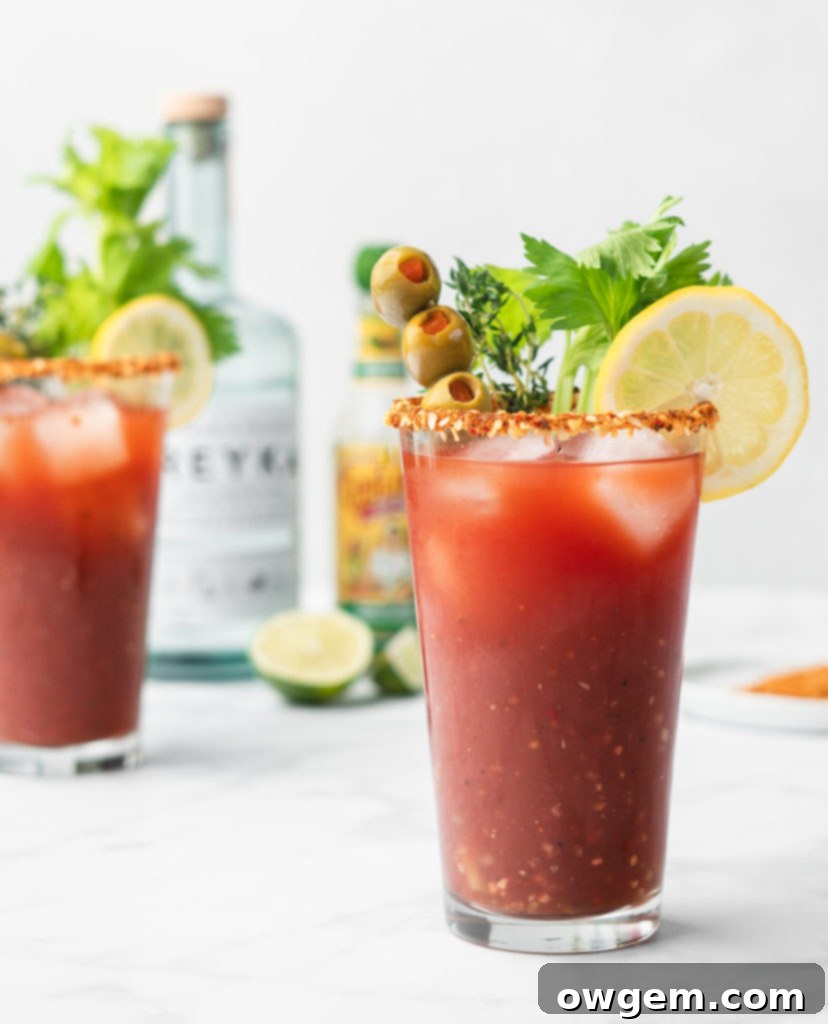 A beautifully garnished Caesar cocktail with a variety of savory and fresh ingredients.