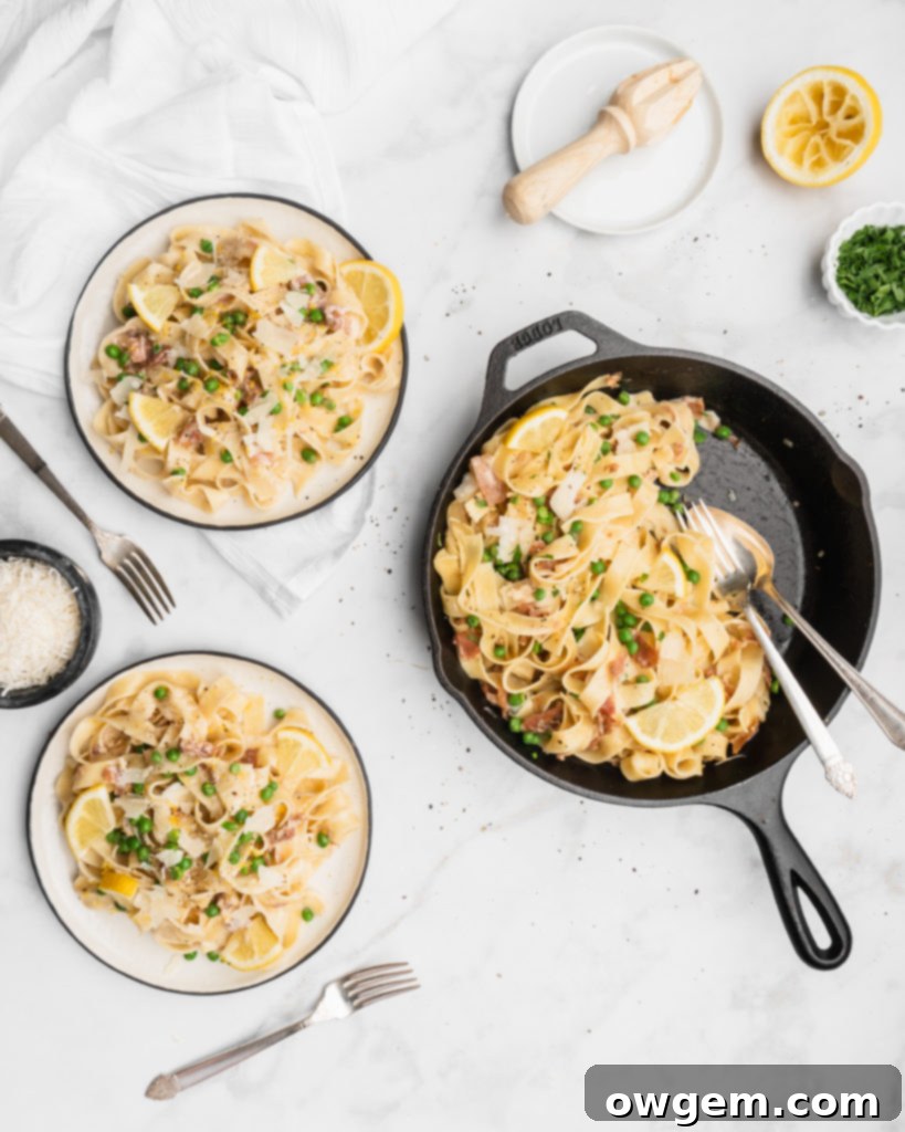 Delicious Lemon Prosciutto and Pea Fettuccine served in a shallow bowl, garnished with fresh parsley and extra Parmesan cheese.