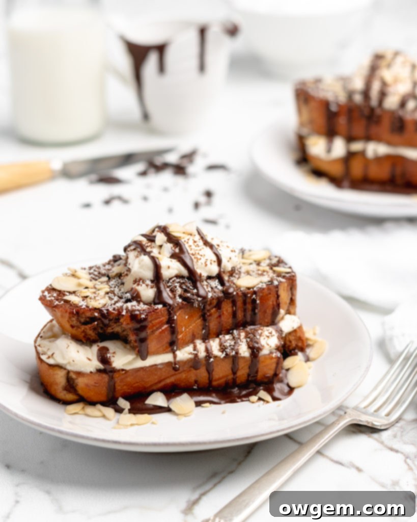 Fluffy Tiramisu flavored French Toast is topped with a delicious dollop of mascarpone whip cream, then drizzled with dark chocolate ganache