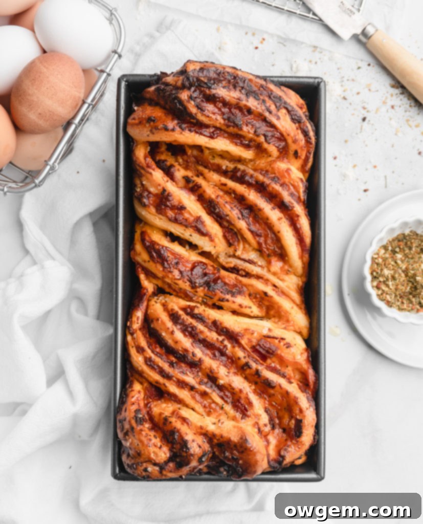 This braided Pizza bread features marinara, mozzarella, and parmesan as a filling, which is then sliced and braided into the bread to create an artistic looking bread