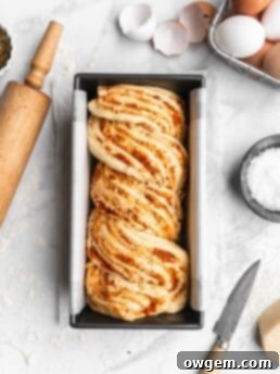 This braided Pizza bread features marinara, mozzarella, and parmesan as a filling, which is then sliced and braided into the bread to create an artistic looking bread