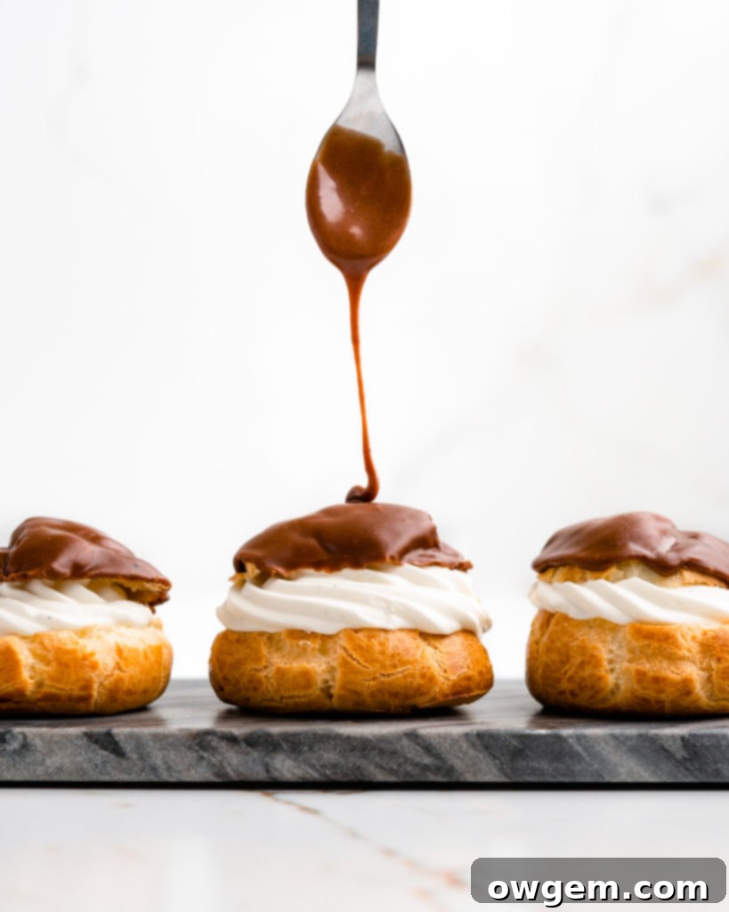 Perfectly puffed cream puffs are filled with a vanilla bean creme diplomat and topped with a chocolate glaze