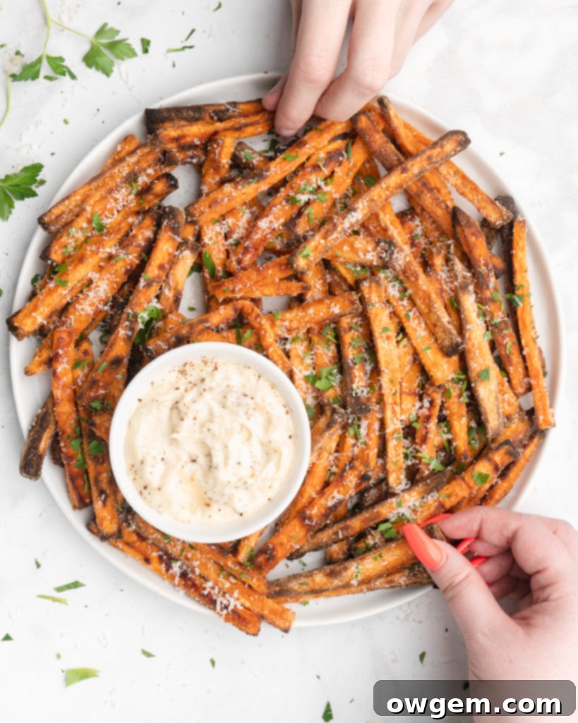 Sweet potato fries being coated with cornstarch in a ziploc bag