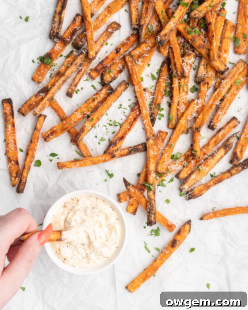 Crispy oven baked sweet potato fries resting on a baking sheet after cooking
