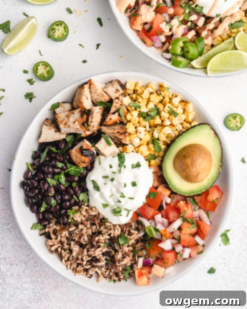 Smooth and creamy homemade chipotle burrito sauce in a glass jar, ready to be drizzled over the chicken burrito bowls.