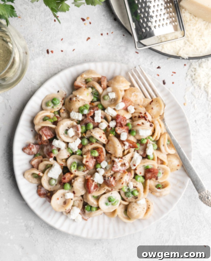 Pasta in a creamy parmesan wine sauce is paired with bits of goat cheese, peas, and crispy pancetta.