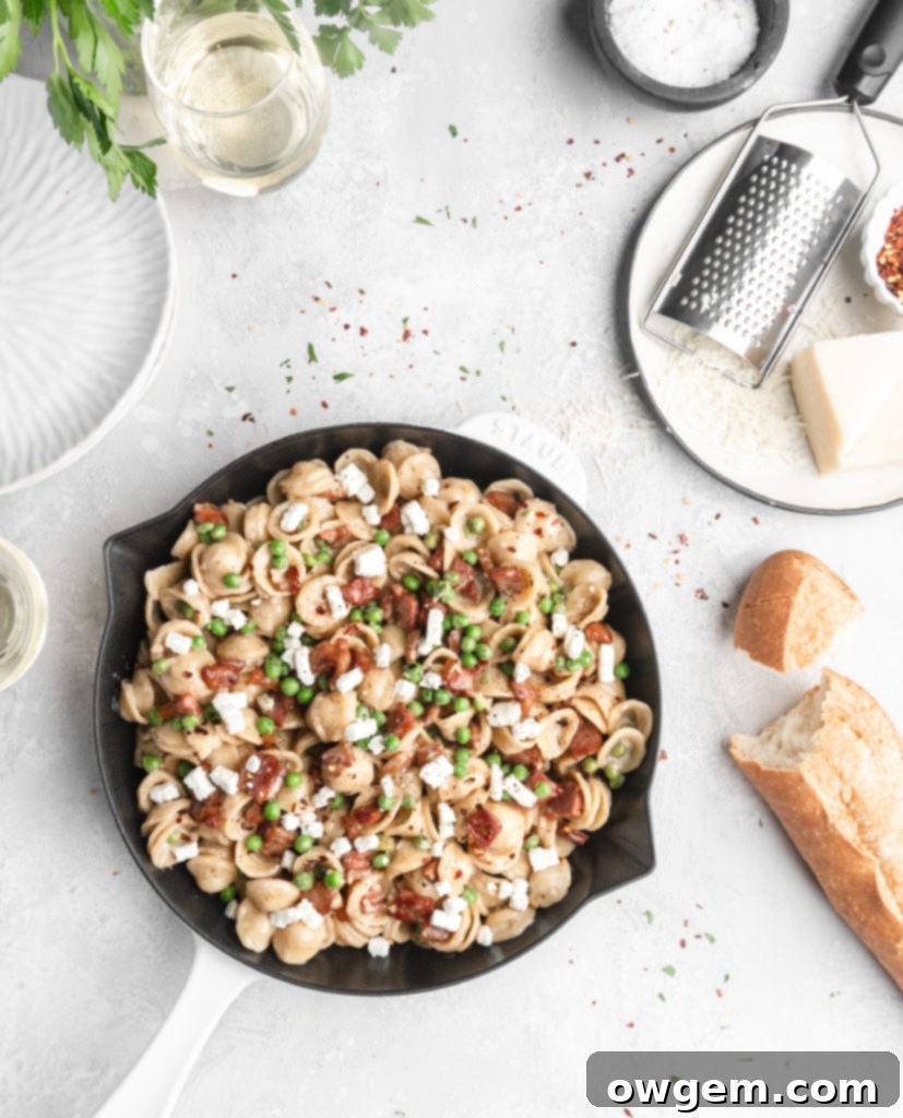 Pasta in a creamy parmesan wine sauce is paired with bits of goat cheese, peas, and crispy pancetta.