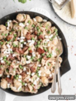 Pasta in a creamy parmesan wine sauce is paired with bits of goat cheese, peas, and crispy pancetta.