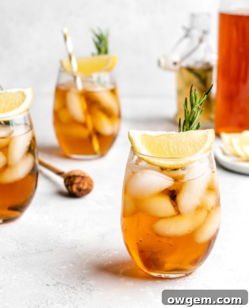 Rosemary sprigs infusing in honey simple syrup in a saucepan, a key step for the Honey Rosemary Iced Tea.
