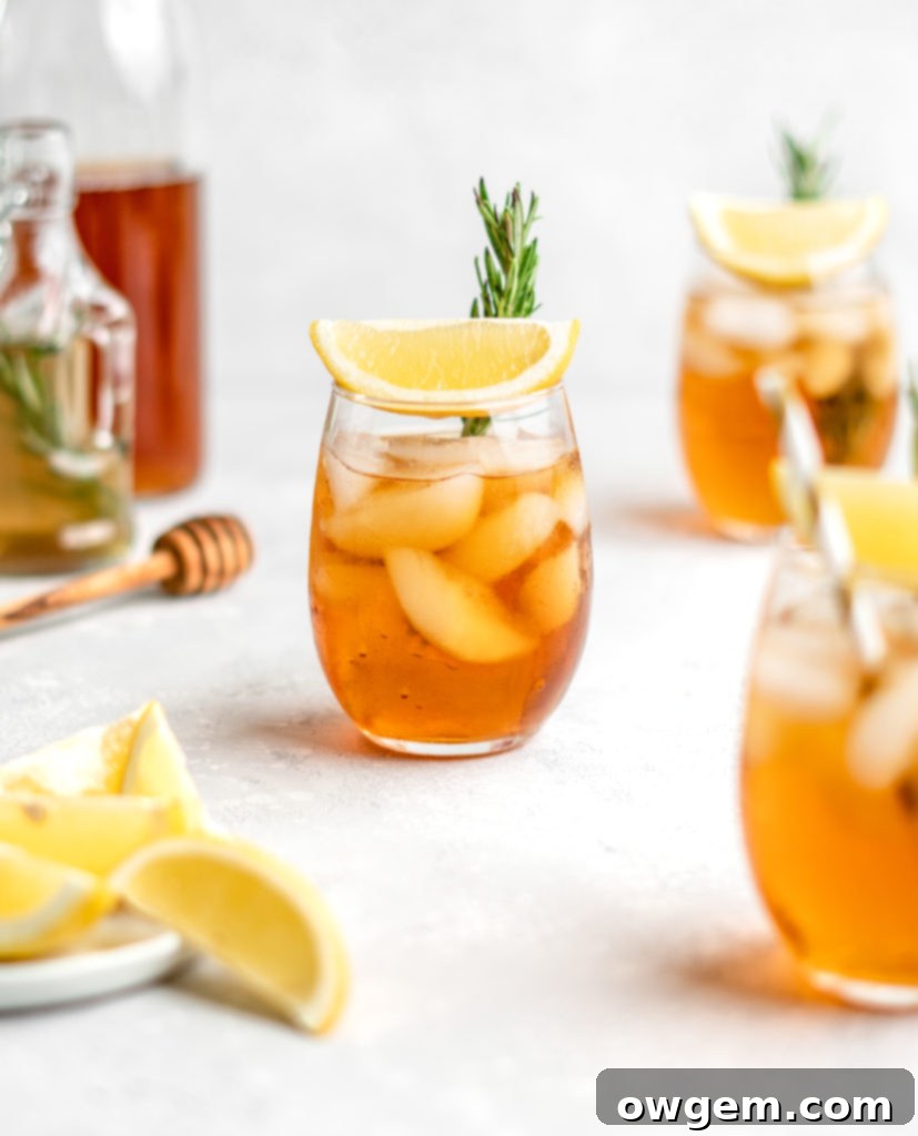 A jar of finished Rosemary Honey Simple Syrup, ready to be used in iced tea recipes.