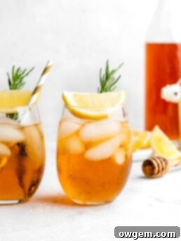 A glass of Honey Rosemary Iced Tea with fresh rosemary garnish.