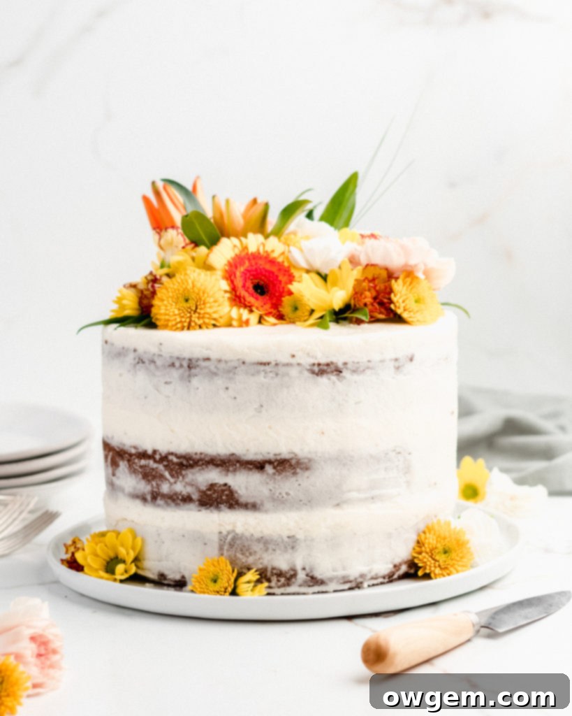 A slice of ultra moist carrot cake with cream cheese frosting, featuring rich spices
