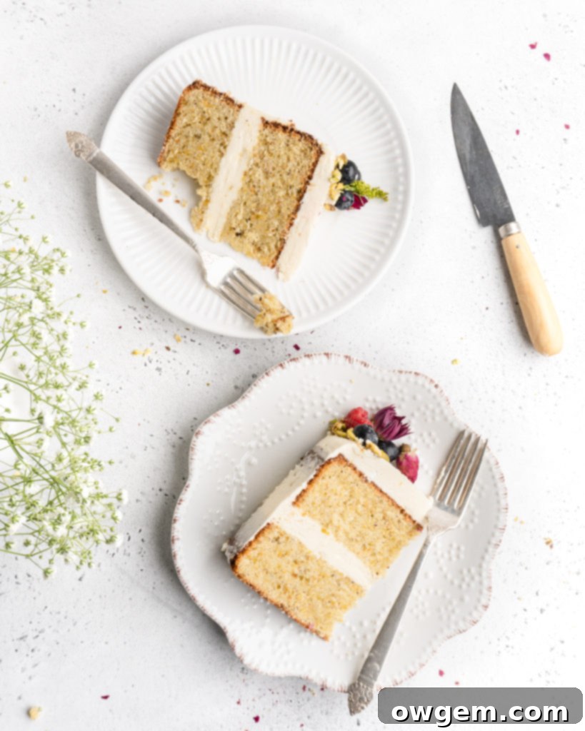 A beautifully decorated Pistachio cake with honey rosewater swiss meringue buttercream, ready for serving