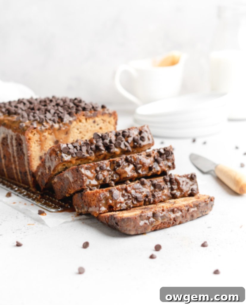 A deliciously moist chocolate chip loaf cake is swirled with dulce de leche, showcasing a beautiful caramel marble effect