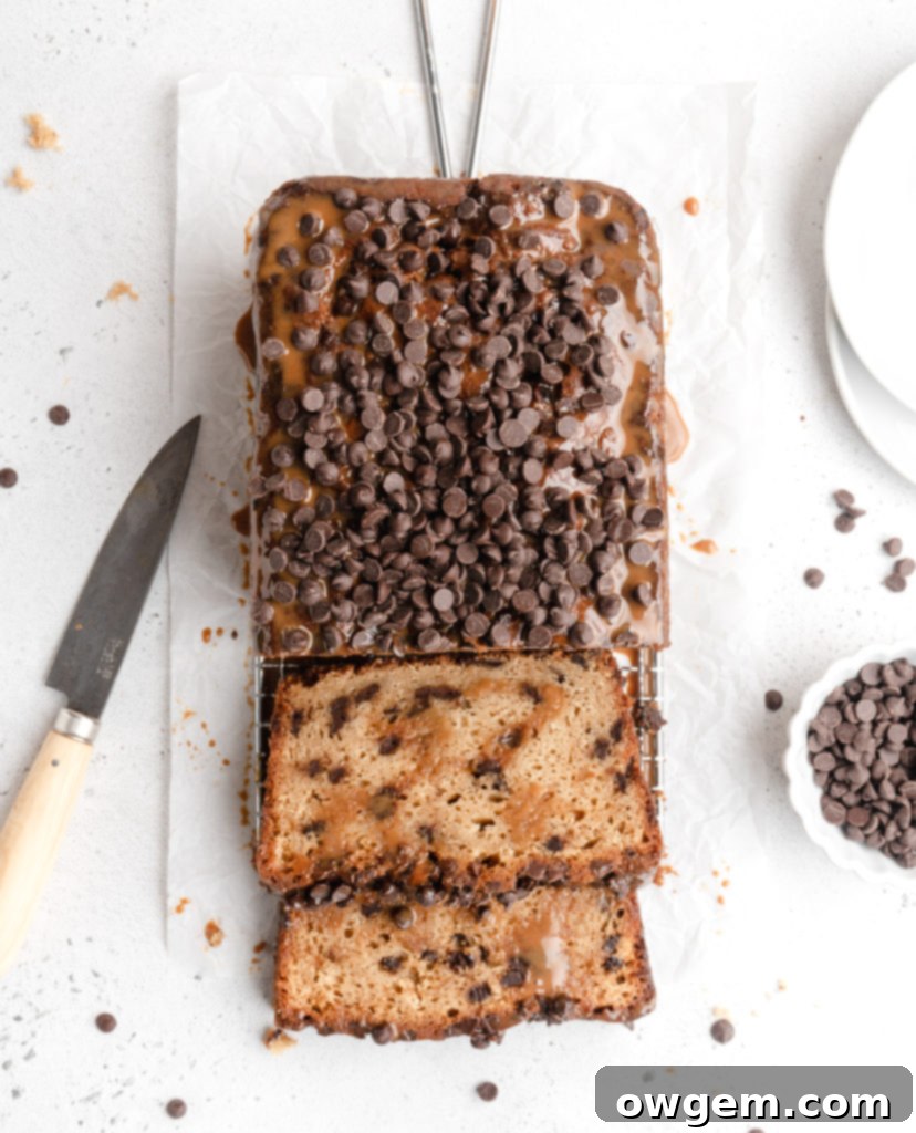 Dulce de leche drizzled over chocolate chip loaf batter in a pan, before swirling