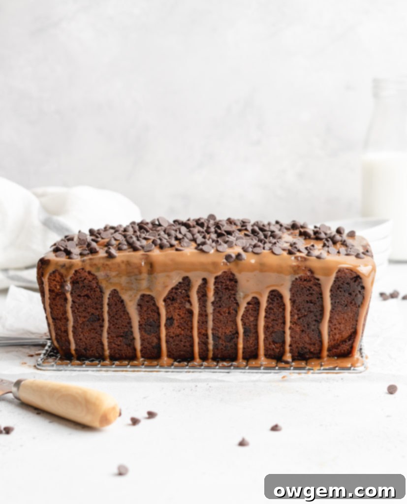 A generous slice of Dulce de Leche Swirl Chocolate Chip Loaf on a plate, showing the rich texture