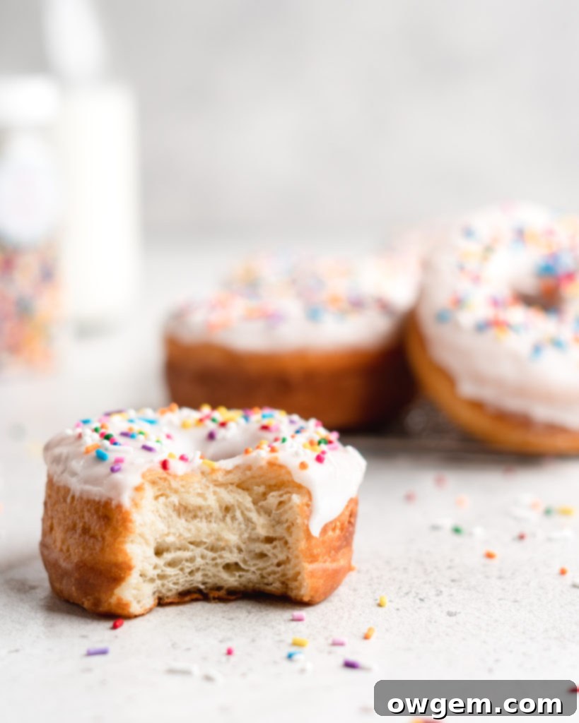 A trio of freshly fried brown butter and vanilla donuts, golden and fluffy, ready for glazing or sugar coating.