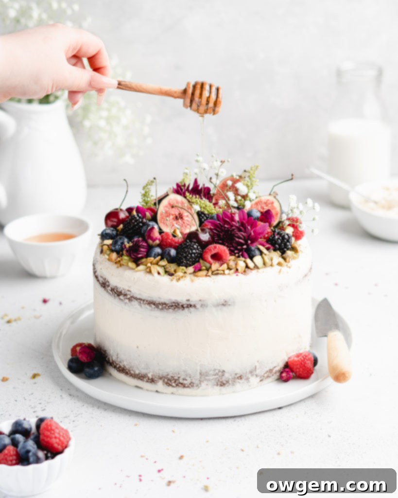 This Pistachio cake is styled in a semi-naked fashion with honey rosewater swiss meringue buttercream