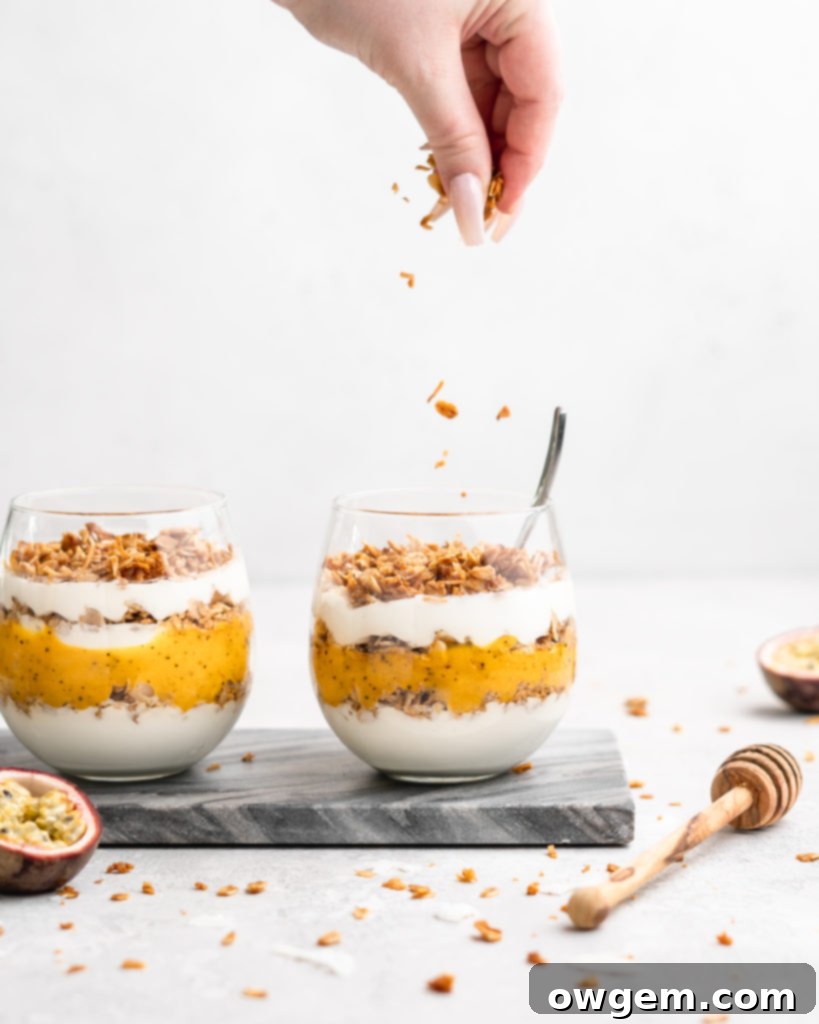 Layers of passion fruit and mango puree, yogurt, and coconut granola make up with tropical yogurt parfait