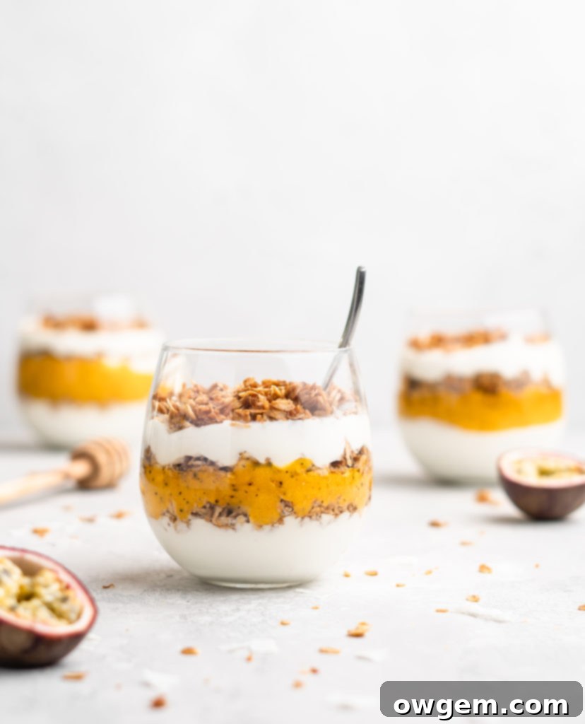 Layers of passion fruit and mango puree, yogurt, and coconut granola make up with tropical yogurt parfait