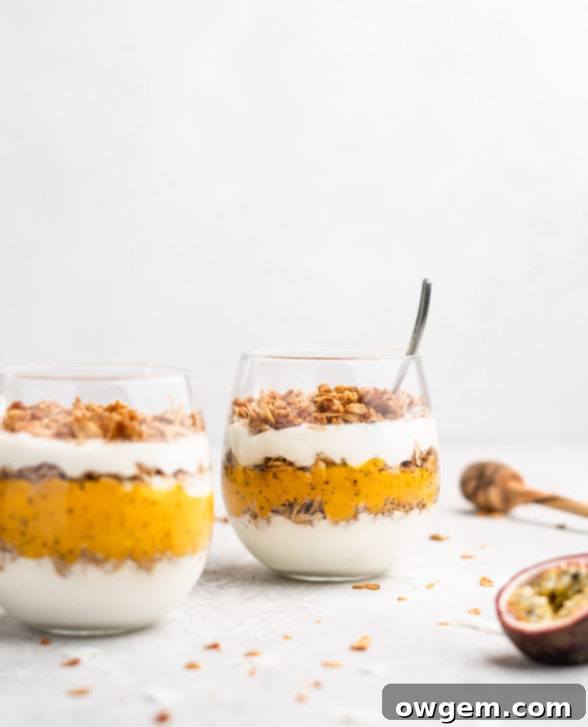 Layers of passion fruit and mango puree, yogurt, and coconut granola make up with tropical yogurt parfait
