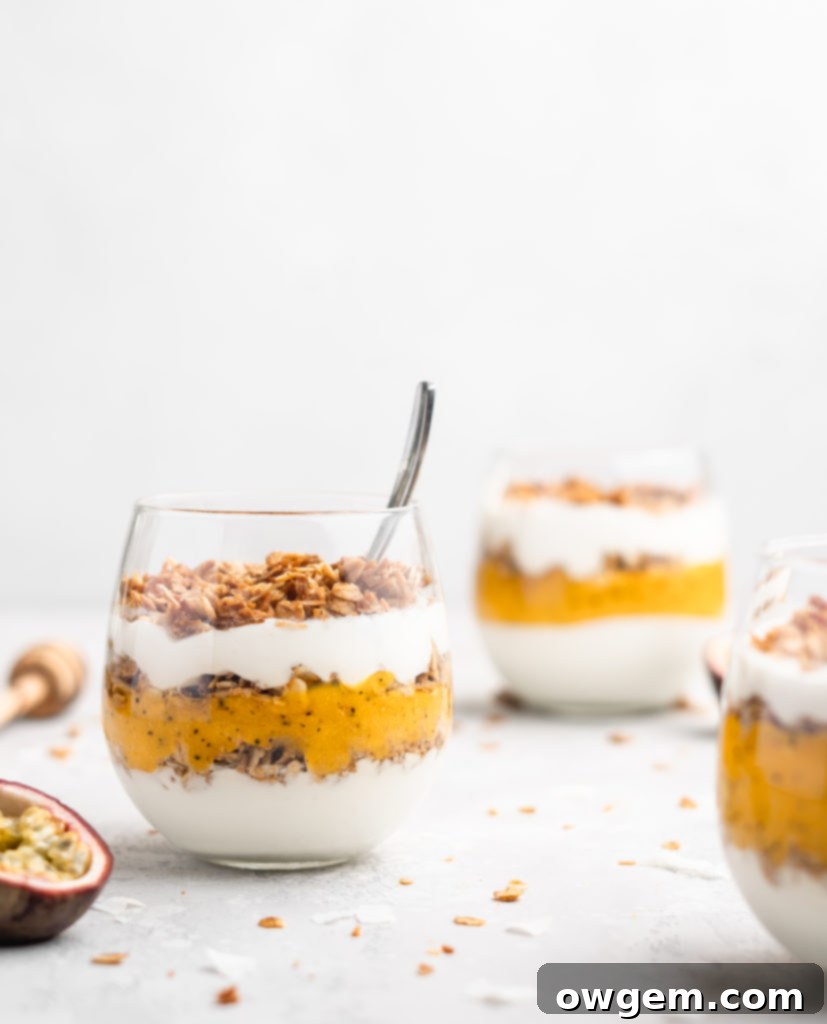 Layers of passion fruit and mango puree, yogurt, and coconut granola make up with tropical yogurt parfait