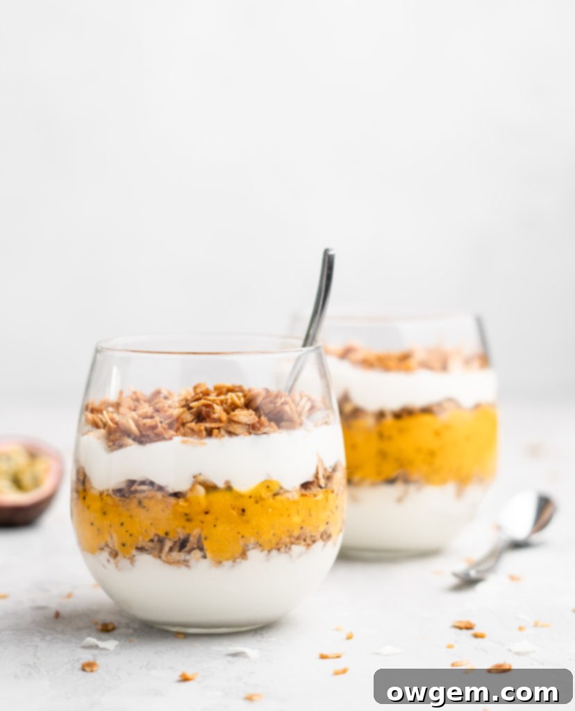 Layers of passion fruit and mango puree, yogurt, and coconut granola make up with tropical yogurt parfait