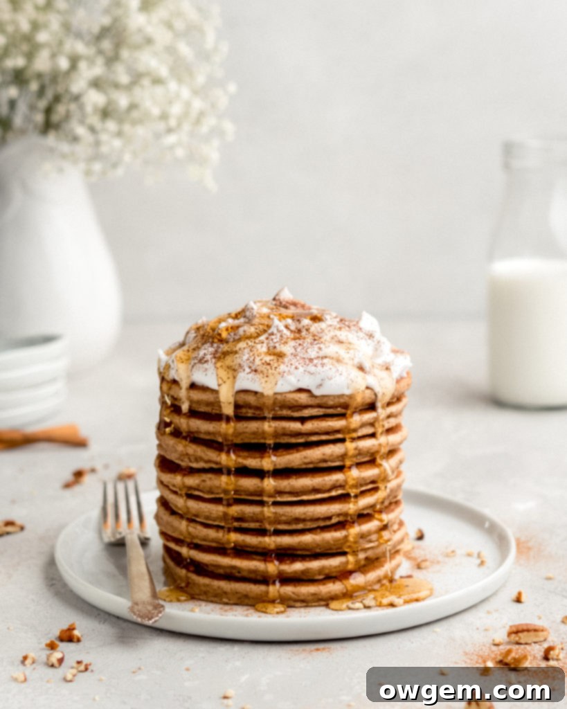 Creamy, smooth cream cheese frosting in a bowl, ready to top cinnamon bun pancakes.