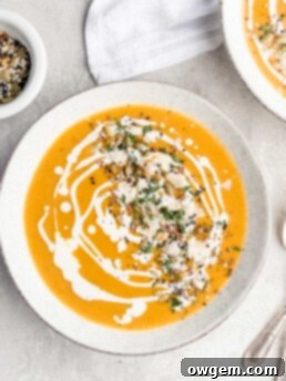 A bowl of creamy Bourbon Butternut Squash Soup, ready to be served and enjoyed.