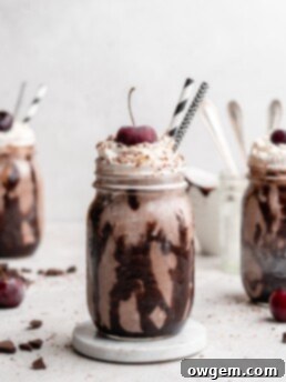 Black Forest Chocolate Cherry Milkshake in a glass with whipped cream and cherry.