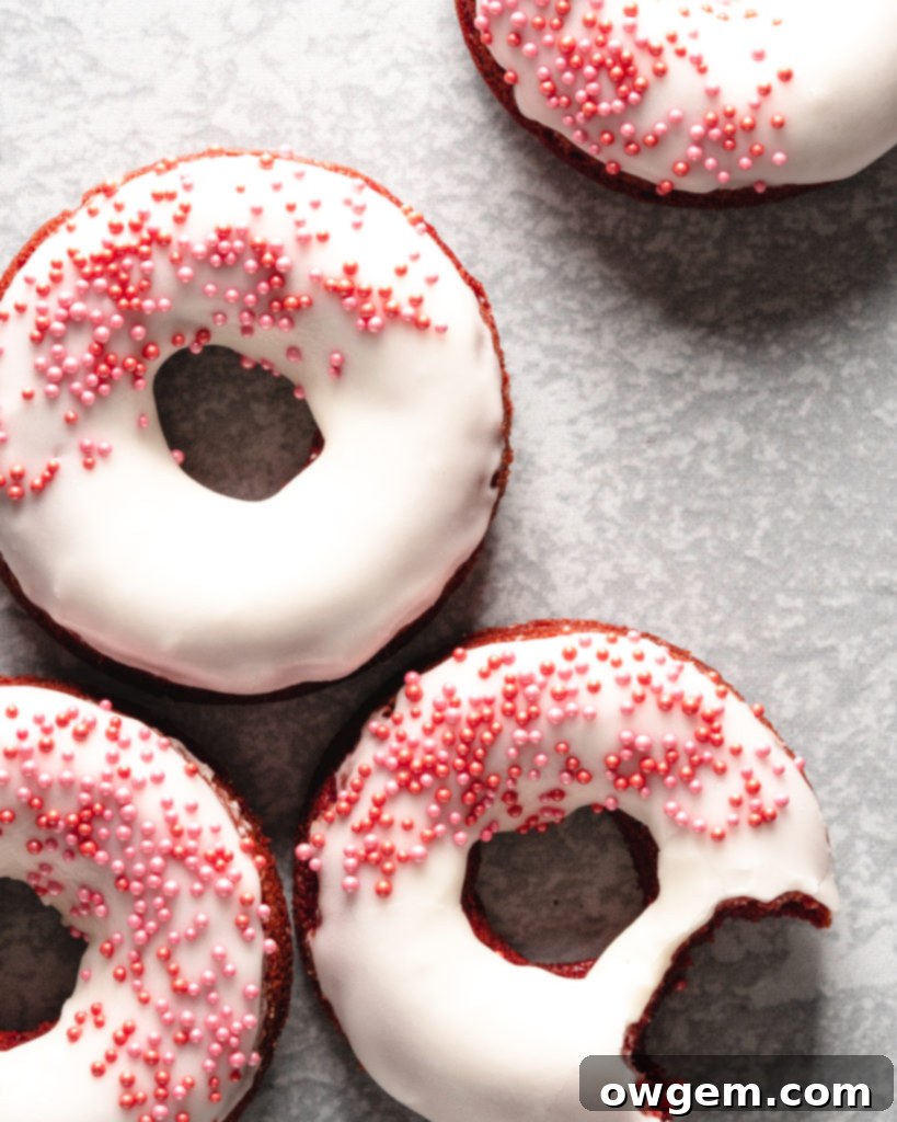 Easy to make baked red velvet donuts are glazed with a cream cheese frosting