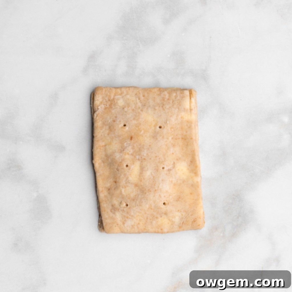 Carefully place the top pastry onto the bottom, aligning the edges.