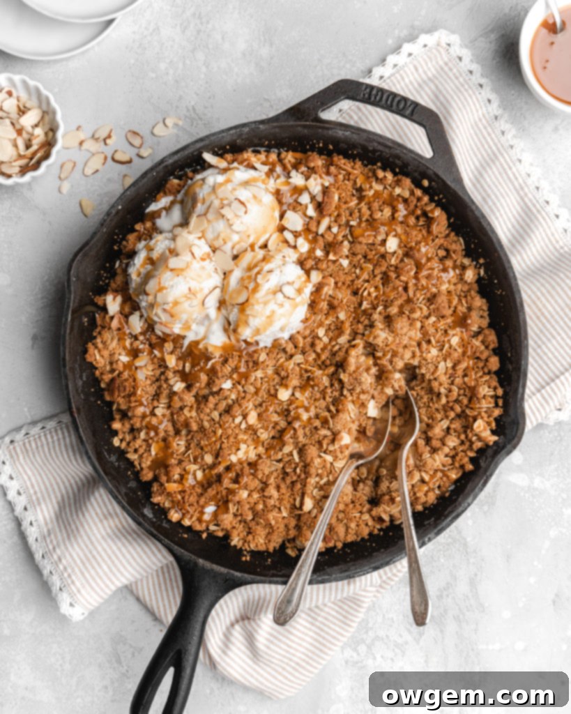 A second close-up image of the baked Maple Cardamom Apple Crisp, emphasizing the texture of the oat and almond topping.