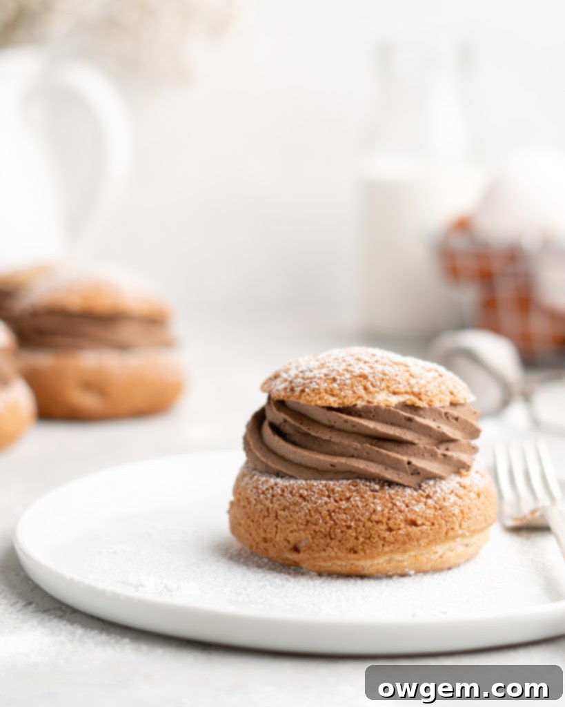 Piping choux pastry for mocha cream puffs with craquelin topping