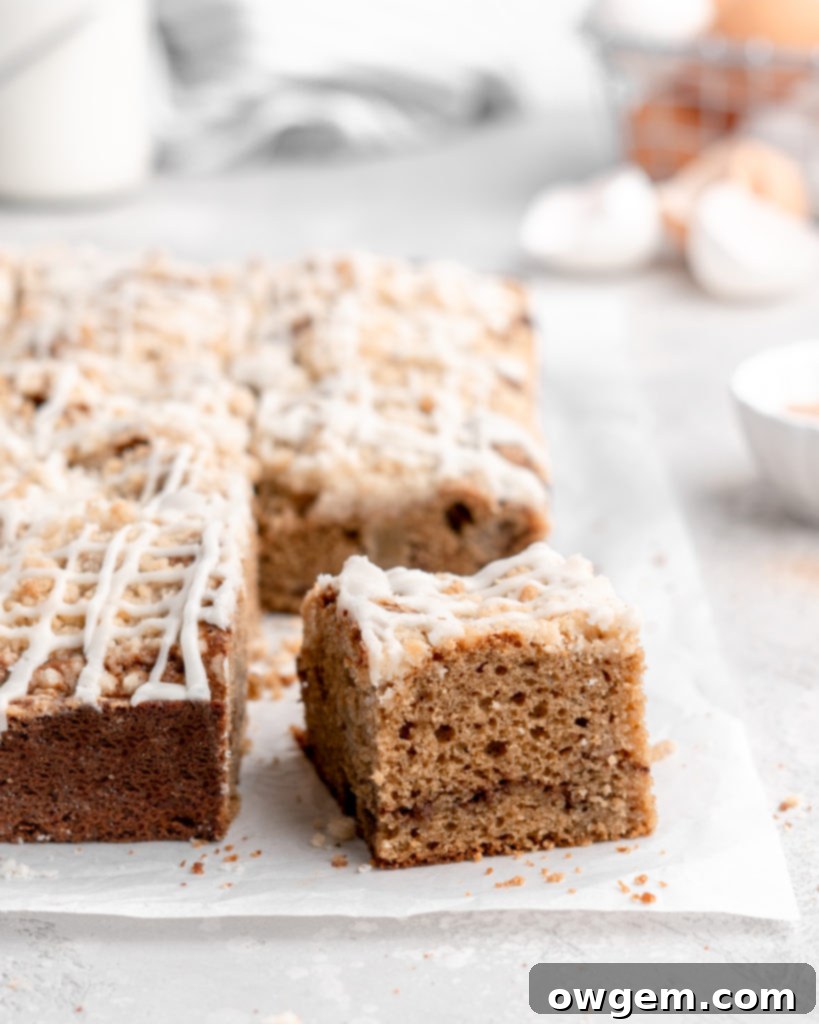 Close-up of the moist Apple Cinnamon Spice Cake with visible apple pieces and a generous streusel topping, showcasing the perfect texture