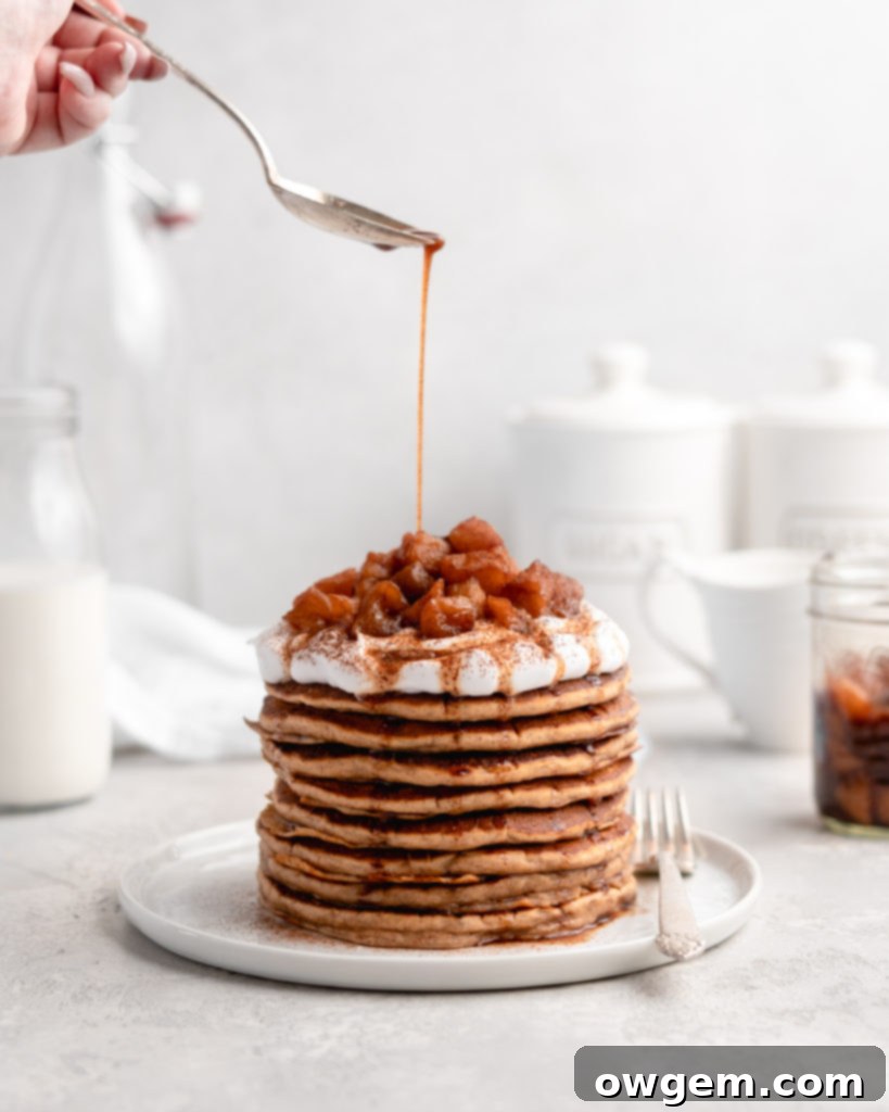 A beautifully styled flat lay of ingredients for apple spice pancakes, including flour, spices, apples, and milk