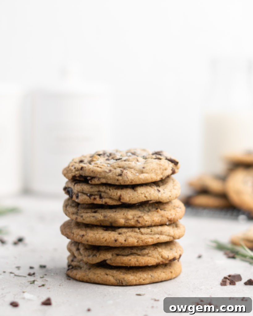 Perfectly chewy Rosemary Chocolate Chunk Cookies with a hint of evergreen flavor and rich chocolate chunks, ideal for the holidays.