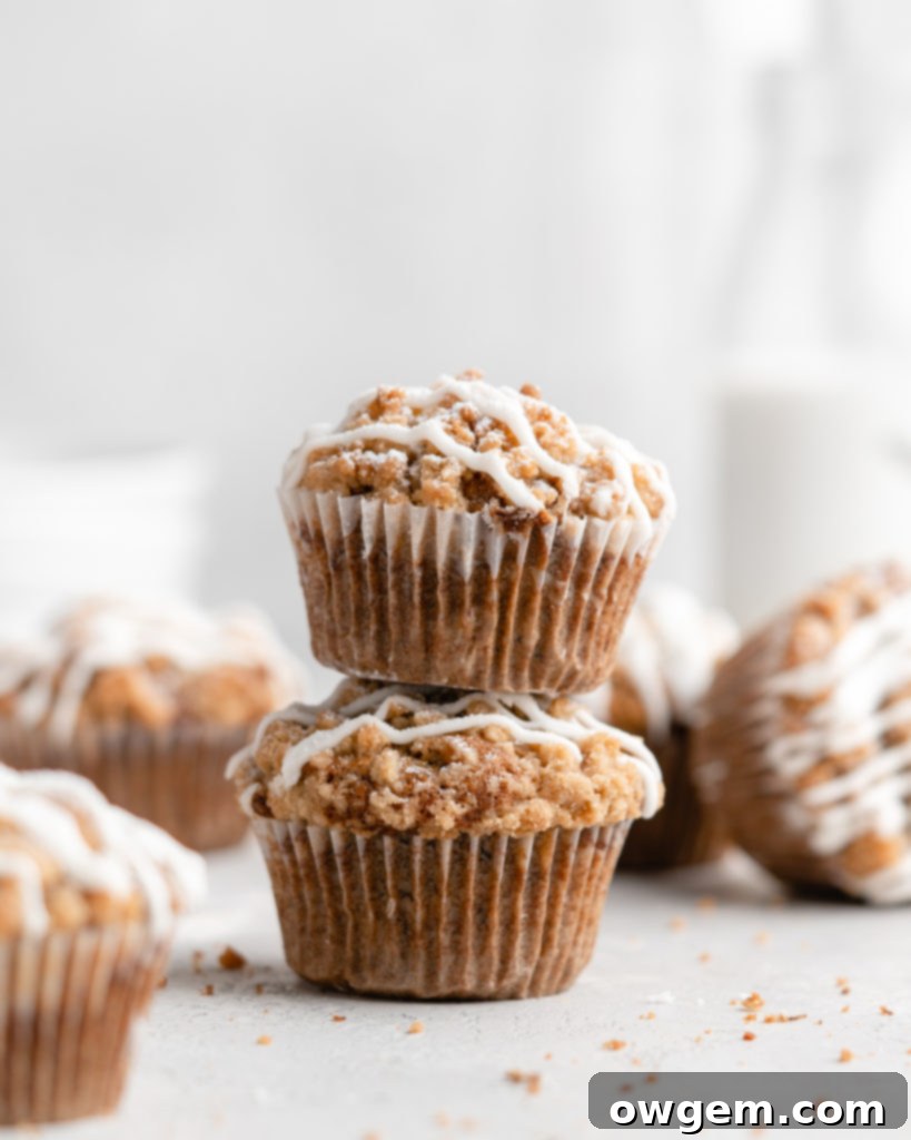 These moist banana muffins are topped with a buttery streusel topping and a simple creamy glaze!